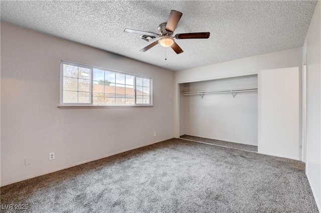 unfurnished bedroom featuring a closet, a textured ceiling, ceiling fan, and carpet flooring