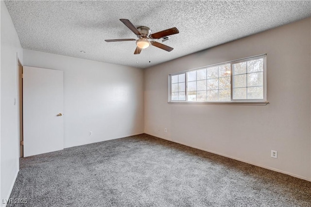 spare room featuring a textured ceiling, ceiling fan, and carpet floors