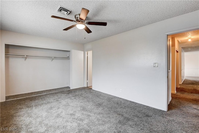 unfurnished bedroom with a closet, visible vents, and a textured ceiling