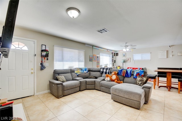 living room featuring ceiling fan and light tile floors