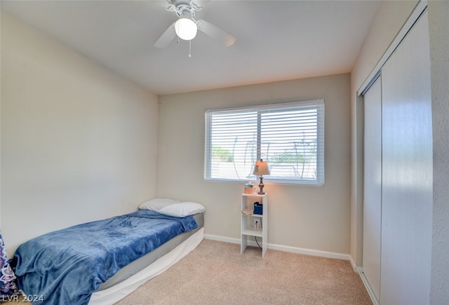 carpeted bedroom with a closet and ceiling fan