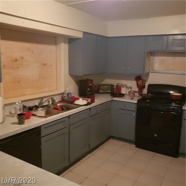 kitchen featuring gray cabinetry, black appliances, sink, and light tile flooring