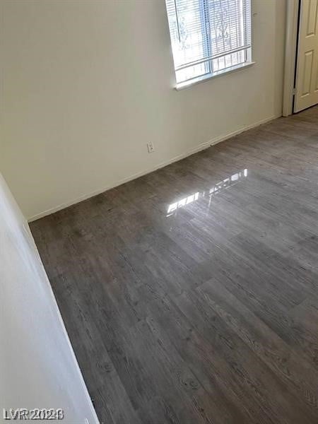 unfurnished room with dark hardwood / wood-style floors