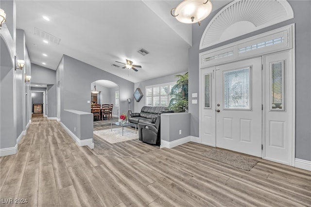 foyer entrance featuring light hardwood / wood-style flooring, vaulted ceiling, and ceiling fan