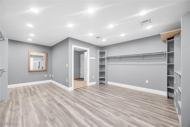 walk in closet featuring wood finished floors and visible vents