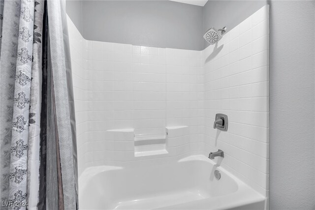 bathroom with shower / tub combo with curtain