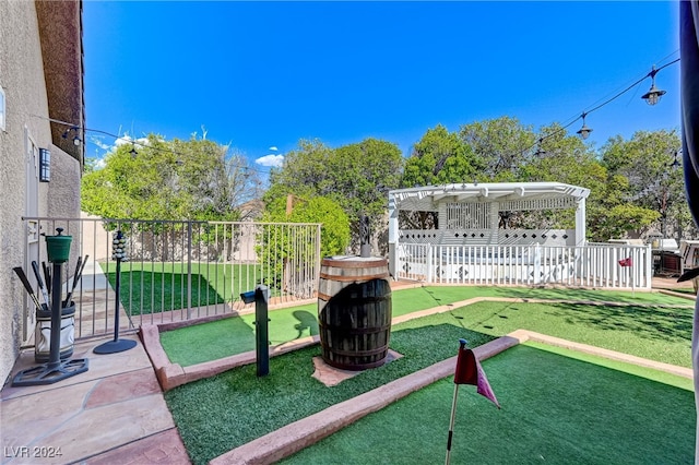 view of play area with a pergola and a patio