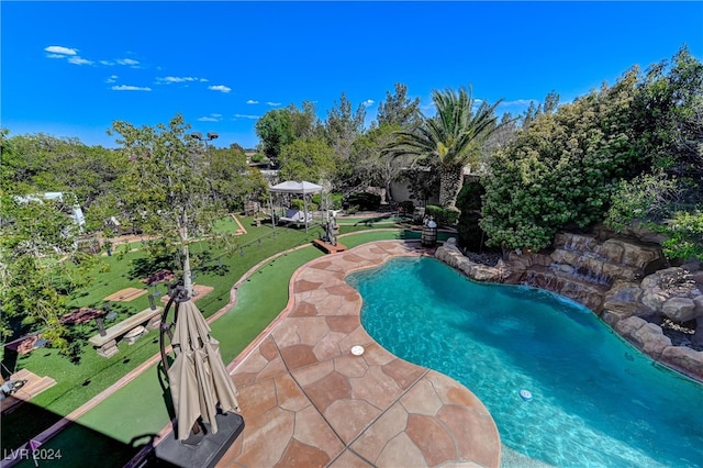 view of swimming pool with a patio