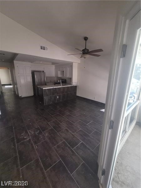 kitchen featuring ceiling fan, lofted ceiling, and sink