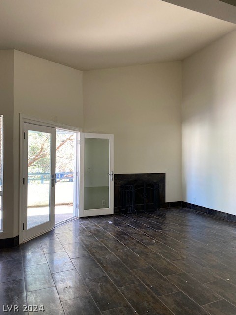 unfurnished living room with dark wood-type flooring