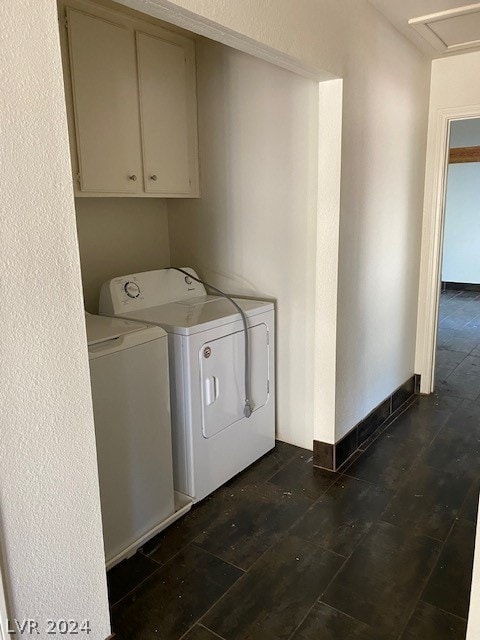 laundry area with separate washer and dryer, cabinets, and dark hardwood / wood-style floors