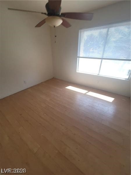 empty room with light hardwood / wood-style floors and ceiling fan