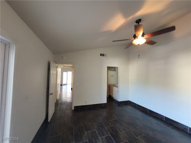 spare room with ceiling fan, dark hardwood / wood-style floors, and lofted ceiling