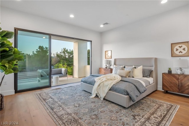 bedroom featuring light hardwood / wood-style floors and access to exterior