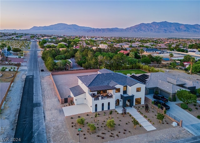 aerial view at dusk featuring a mountain view