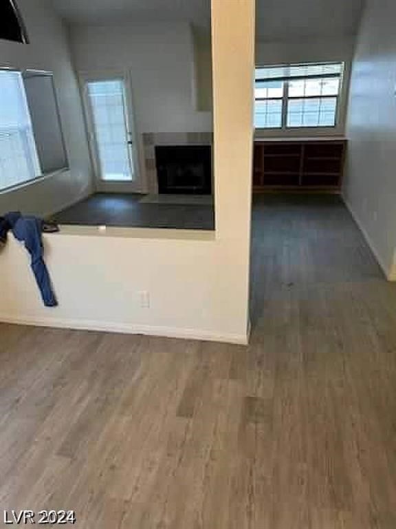 unfurnished living room with dark hardwood / wood-style floors