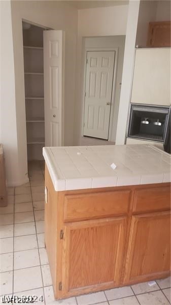 kitchen featuring tile counters and light tile floors