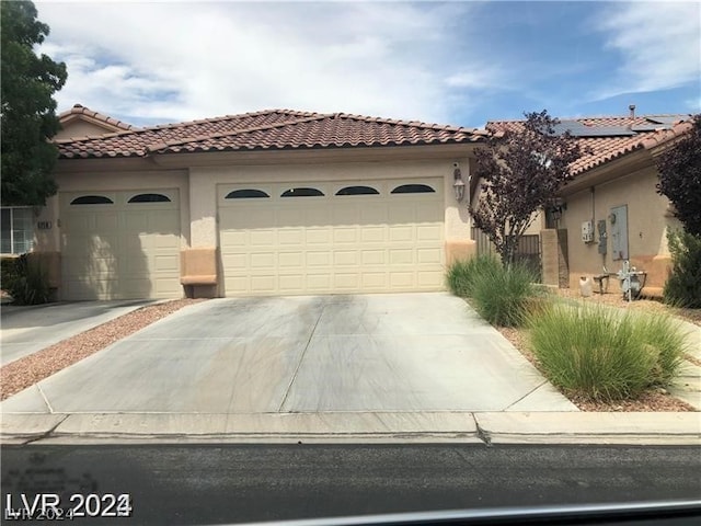 mediterranean / spanish-style house featuring a garage