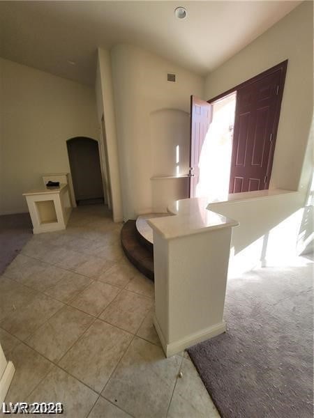 kitchen featuring kitchen peninsula and light tile floors