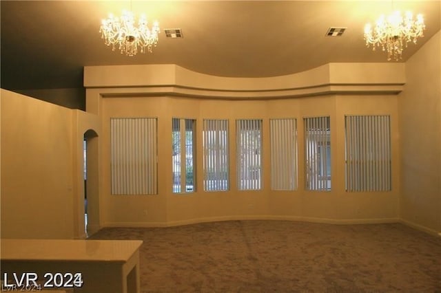 entrance foyer featuring a notable chandelier and carpet