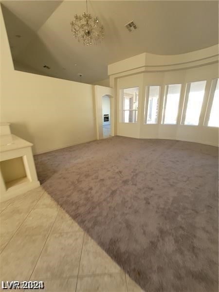 interior space featuring a notable chandelier and vaulted ceiling