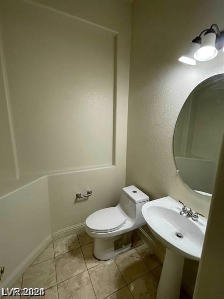 bathroom featuring toilet and tile flooring