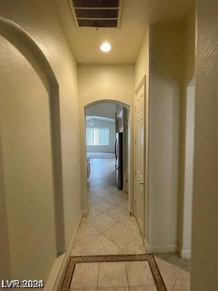 corridor with light tile floors