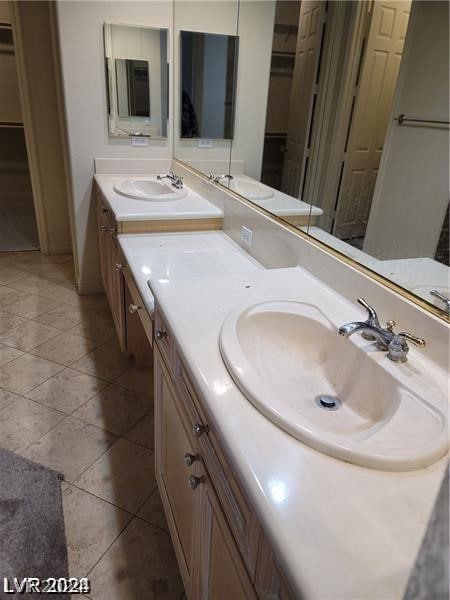 bathroom with tile flooring and double sink vanity