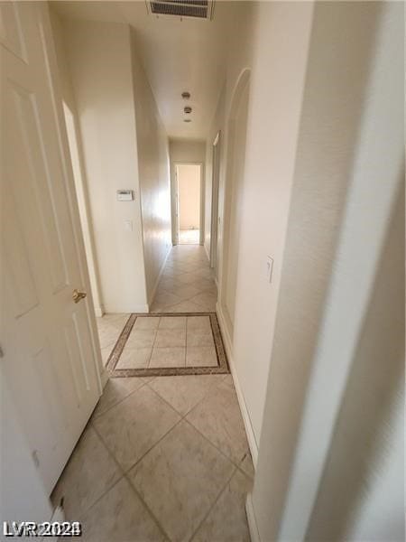 corridor featuring light tile floors