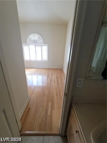 interior space with vanity and hardwood / wood-style flooring