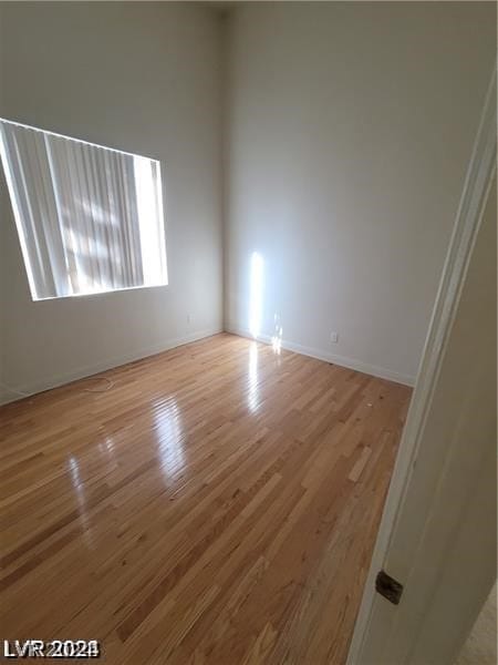 spare room with hardwood / wood-style floors