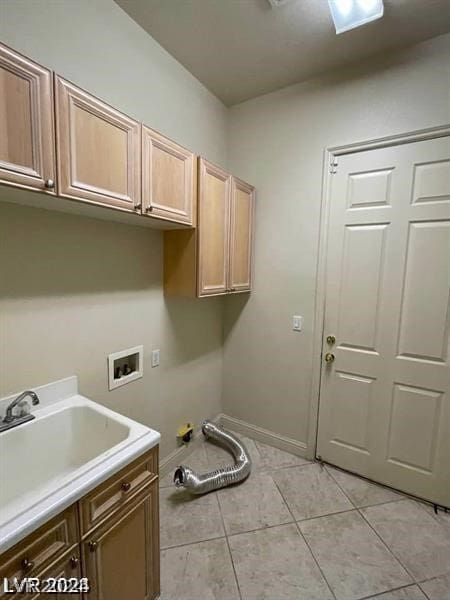 clothes washing area with sink, light tile flooring, cabinets, and hookup for a washing machine