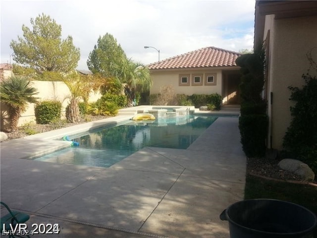 view of swimming pool with a patio area