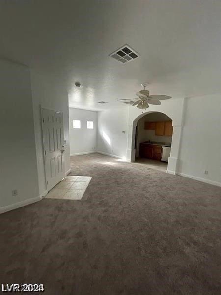 interior space with ceiling fan and carpet