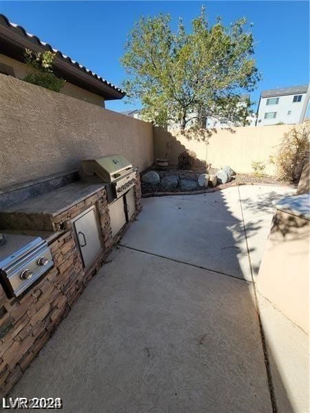 view of patio with a grill and an outdoor kitchen