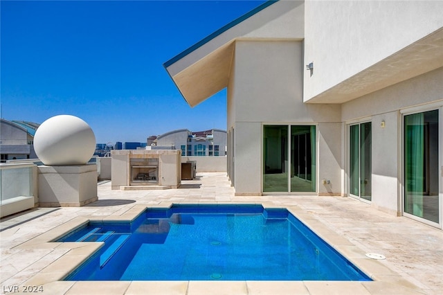 view of swimming pool featuring a patio and an outdoor kitchen