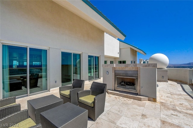 view of patio / terrace featuring an outdoor fireplace