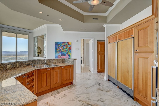 kitchen featuring light stone countertops, ceiling fan, sink, and light tile flooring