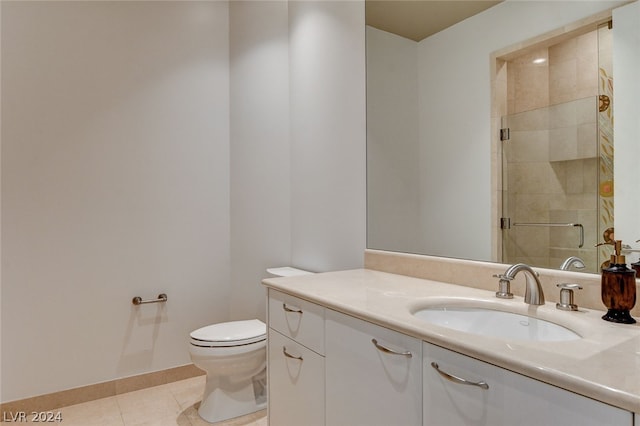 bathroom featuring vanity, tile floors, toilet, and tiled shower