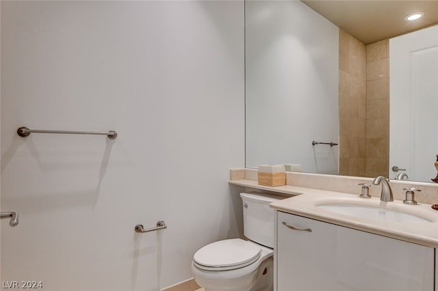 bathroom featuring toilet and vanity