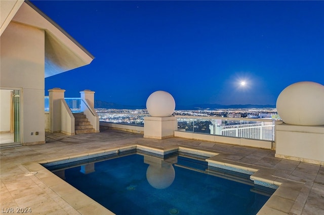 view of pool at twilight