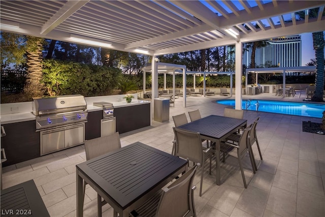 view of terrace with a grill, a pergola, exterior kitchen, and a fenced in pool