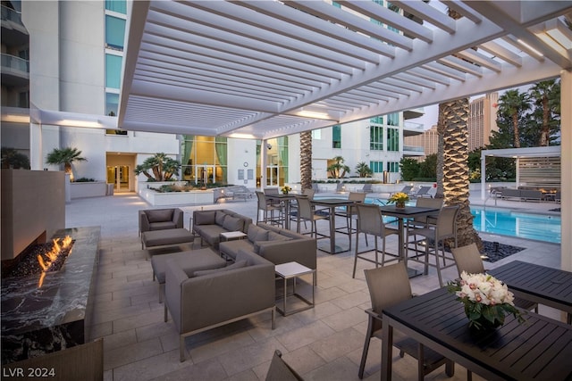 view of patio / terrace with outdoor lounge area, a bar, and a pergola