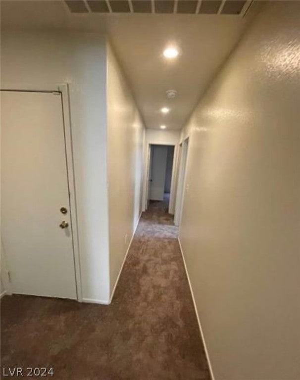 corridor featuring dark carpet