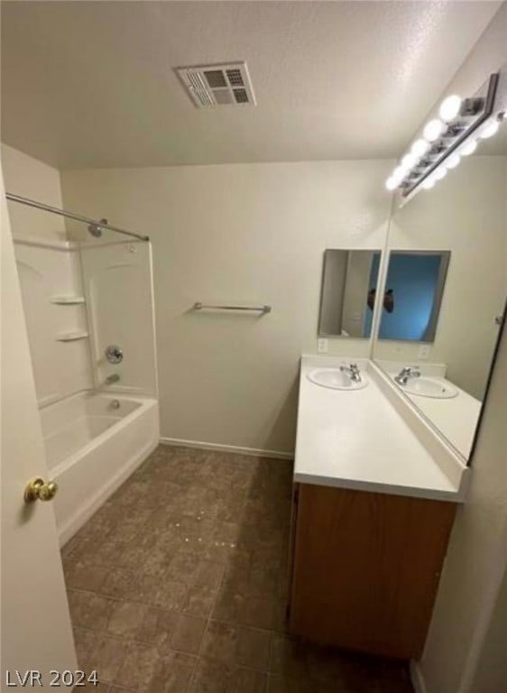 bathroom featuring shower / bathing tub combination, vanity, and tile flooring