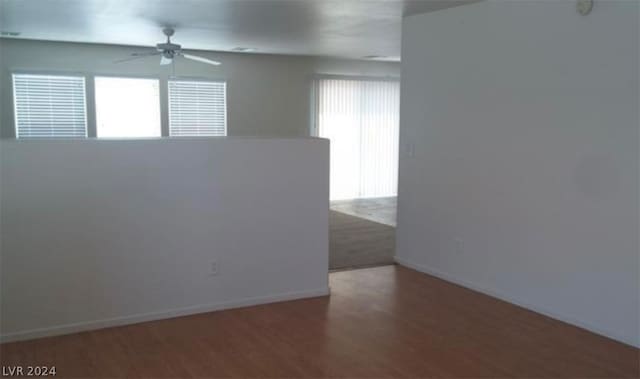 unfurnished room with wood-type flooring, ceiling fan, and a healthy amount of sunlight