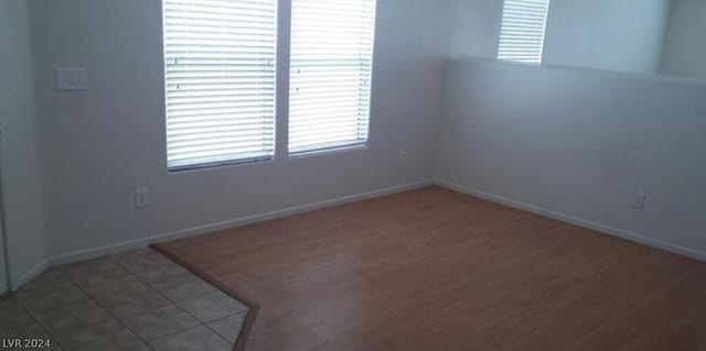 spare room with wood-type flooring