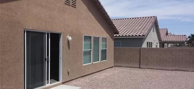 view of side of home featuring a patio area