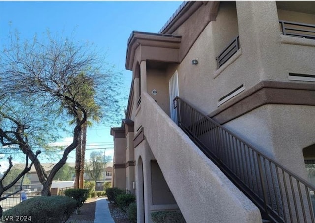 view of side of home with a balcony