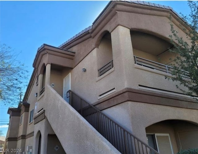 view of side of home with a balcony